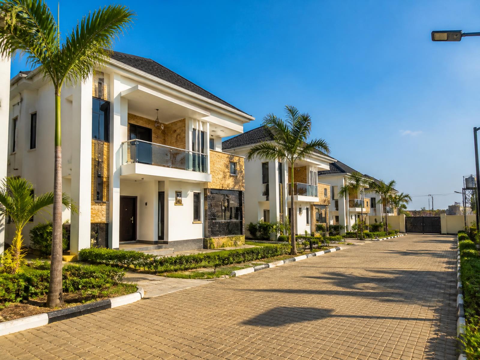Modern duplexes on a landscaped street in a Nigerian gated estate